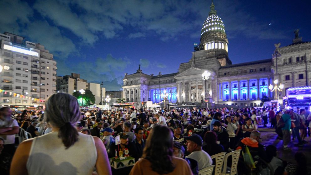 Buenos Aires, Argentina - December 24, 2024: General view of homeless and low-income people receive a Christmas dinner provided by several social movements that meet in front of the National Congress to organize a solidarity Christmas dinner in the midst