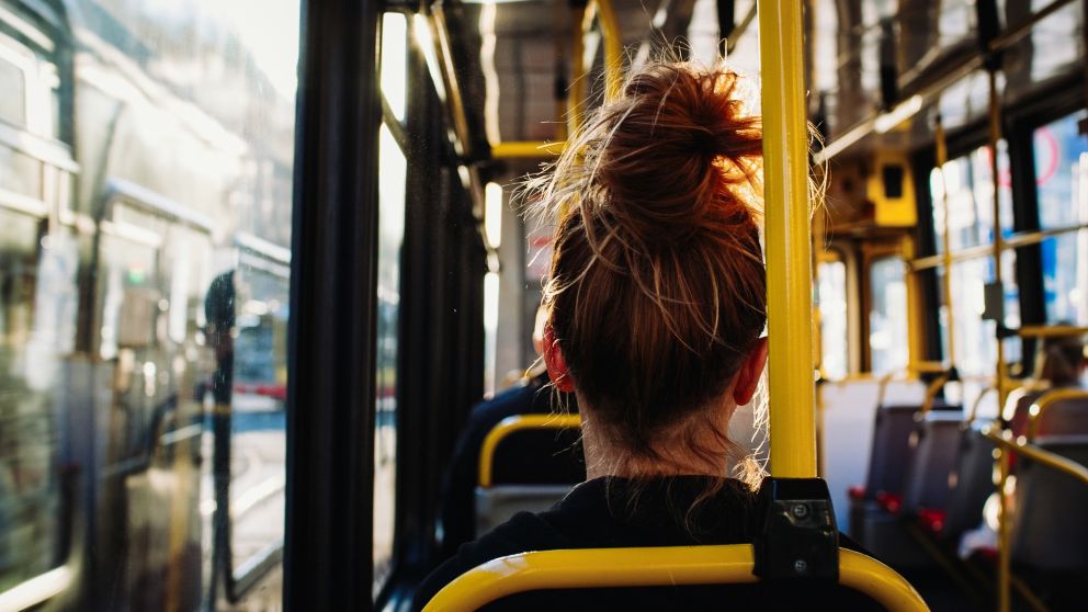 Female sitting in the bus captured from behind