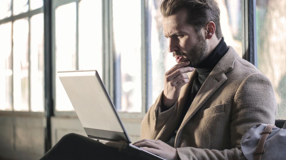 El hombre lee mails, camina y come sandwichs en su trabajo