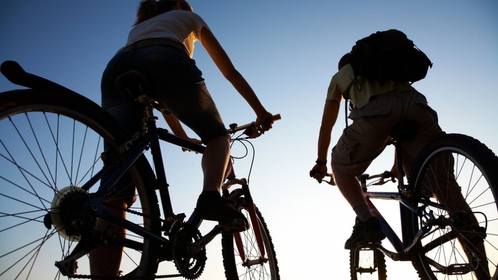 Beautiful,Couple,On,Bicycles,On,The,Brink,Of,A,Rock