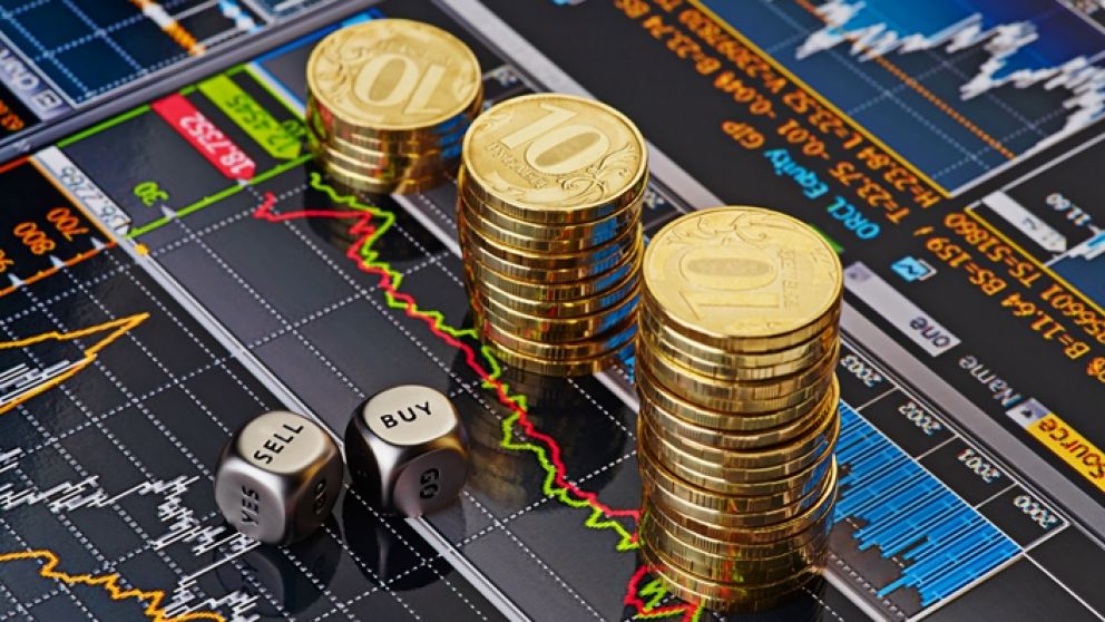 Dices cubes with the words SELL BUY, downtrend stacks of golden coins. Financial chart as background. Selective focus