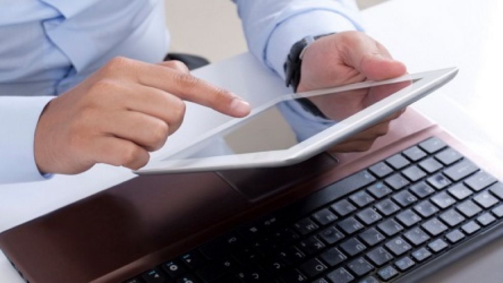 creating a business plan on a digital tablet and laptop