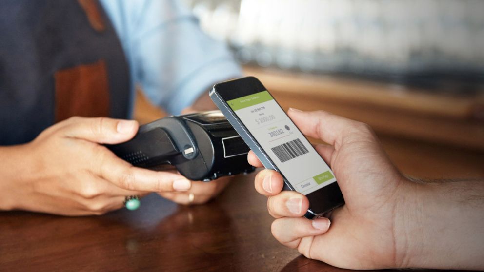 Cropped shot of a customer paying with a smartphone at a bar-Model and Property Released (MR&PR)